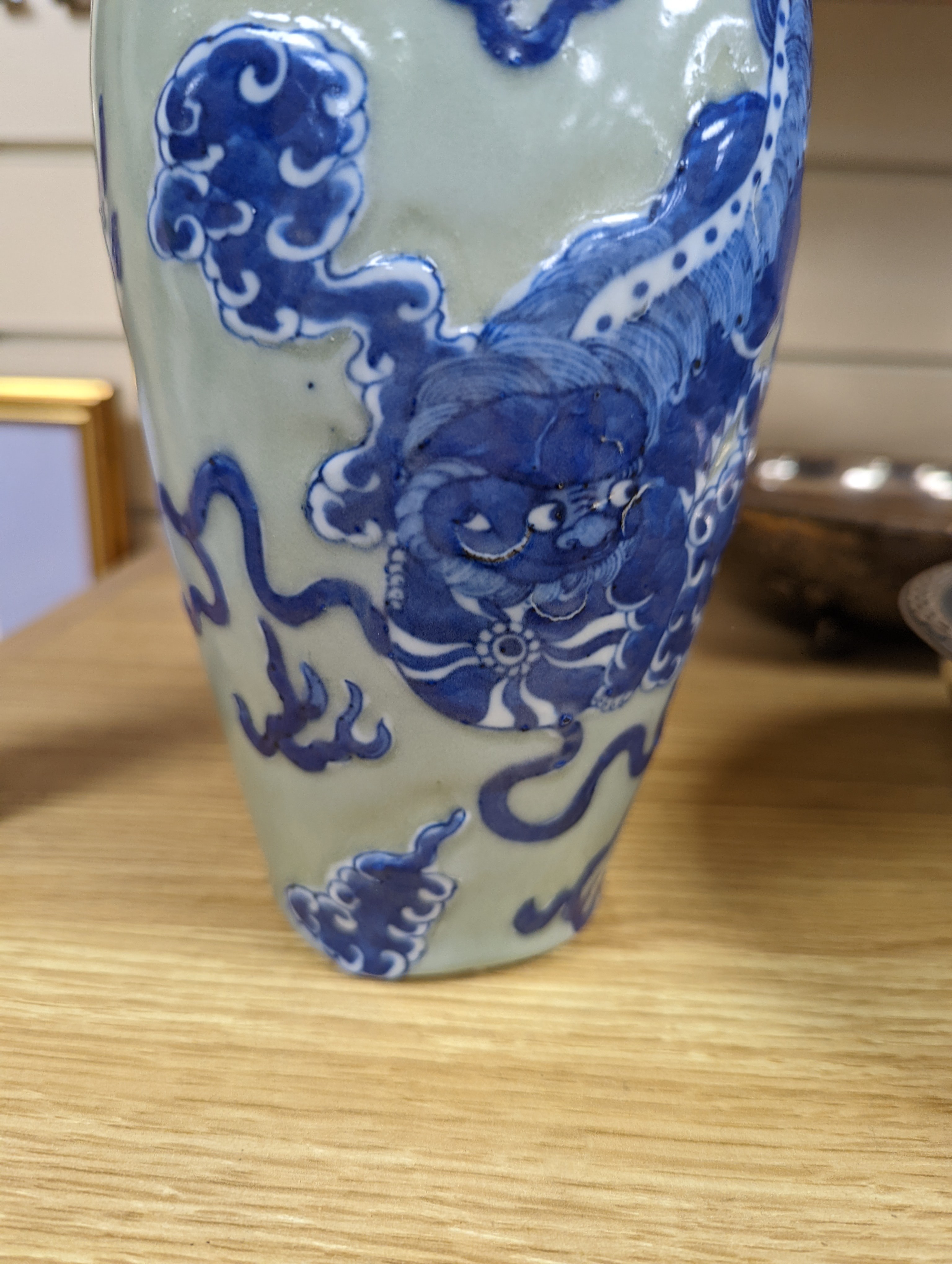 A Chinese celadon glazed vase, 24cm and a Chinese famille rose teapot and matching cream jug, a.f.